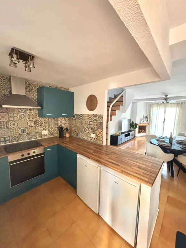 Keuken, met oven en gasfornuis. Achter het keukenblad is de woonkamer.